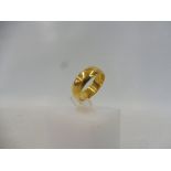 A 22ct gold wedding band, weighs approx. 7.2g.