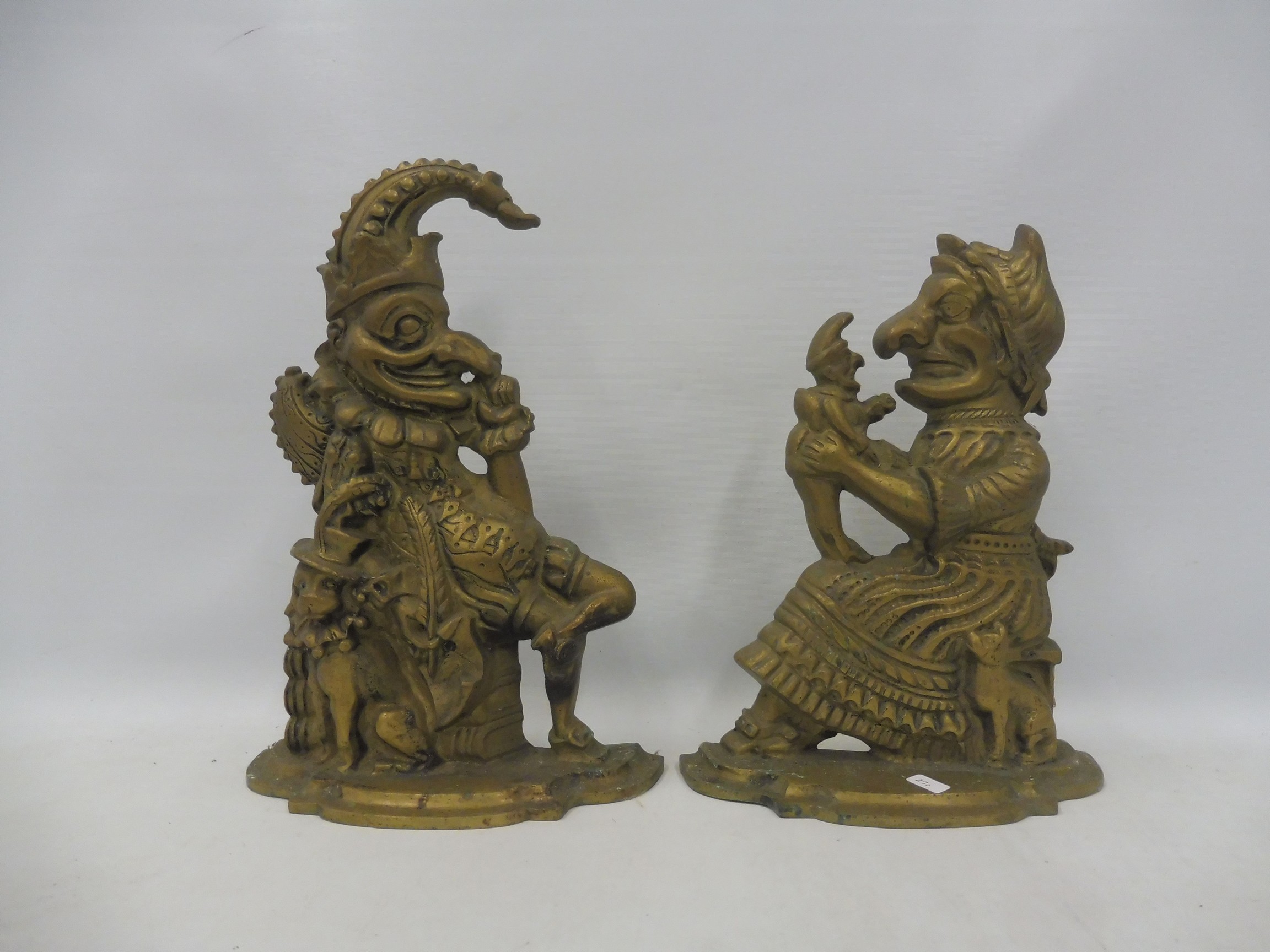 A pair of heavy brass doorstops in the form of Mr and Mrs Punch.