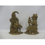 A pair of heavy brass doorstops in the form of Mr and Mrs Punch.