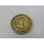 A 19th Century brass circular snuff box bearing the side profile of Charles James Fox to the lid.