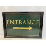 A painted wooden pub sign for 'Entrance'.