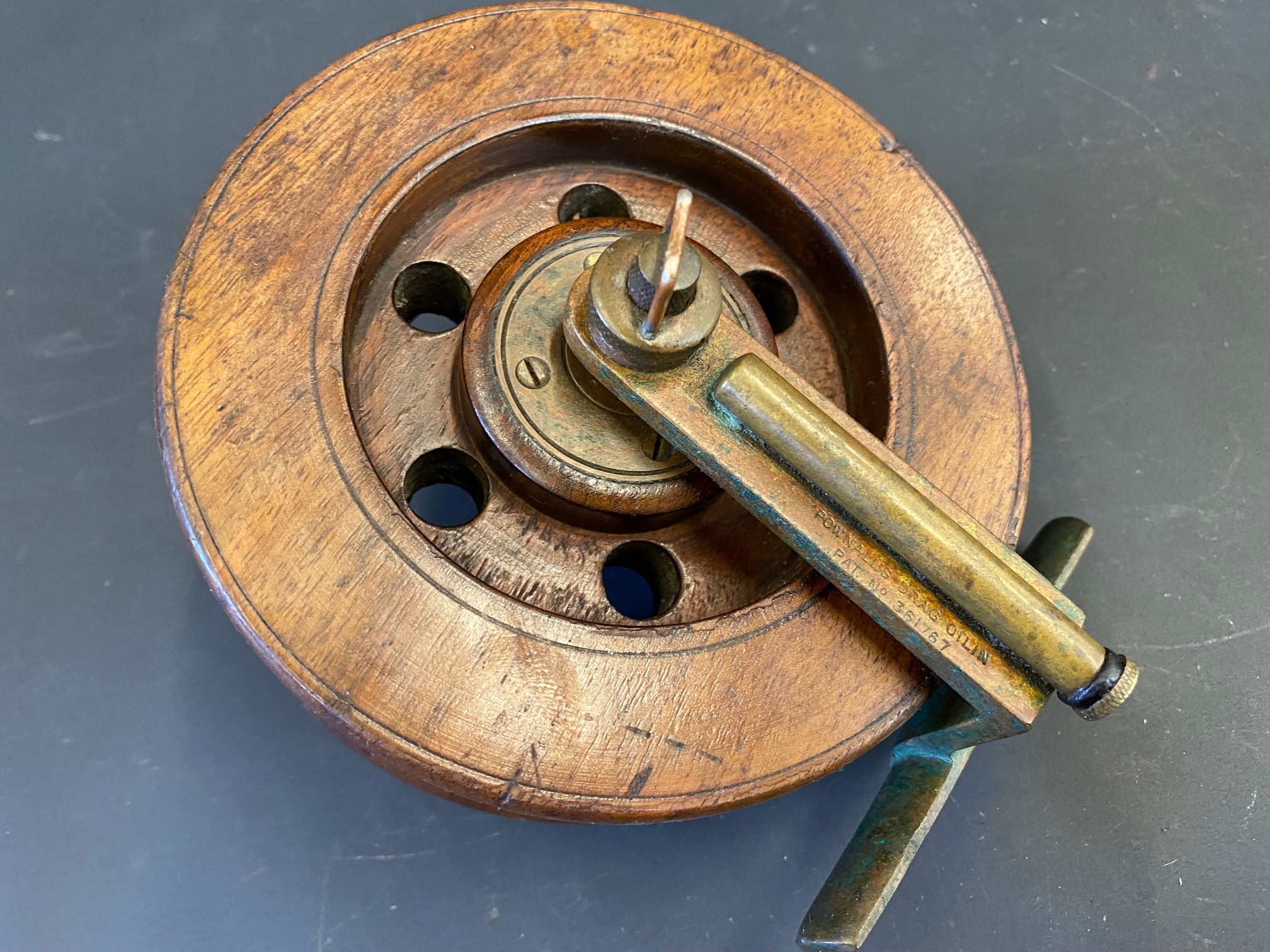 A Pownall's Drag Oilin Patent no. 361767 5" wooden centre pin reel.