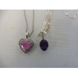 A pink heart shaped sapphire and silver pendant on silver chain and an amethyst pendant on silver