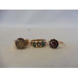 A 9ct gold ring set with seed pearls and green stones, size P, a 9ct gold ring set with garnets,