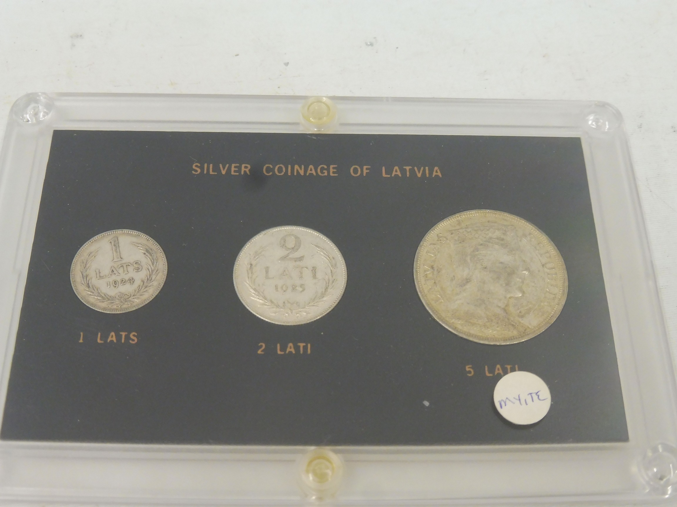 Three Latvian silver coins, a 1924 1 Lats, a 1925 2 Lati and a 1929 5 Lati coin, in presentation