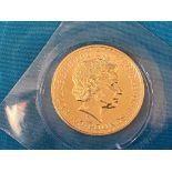 A rare gold 100 Pounds coin in plastic sleeve, overall weight approx. 35.7g.