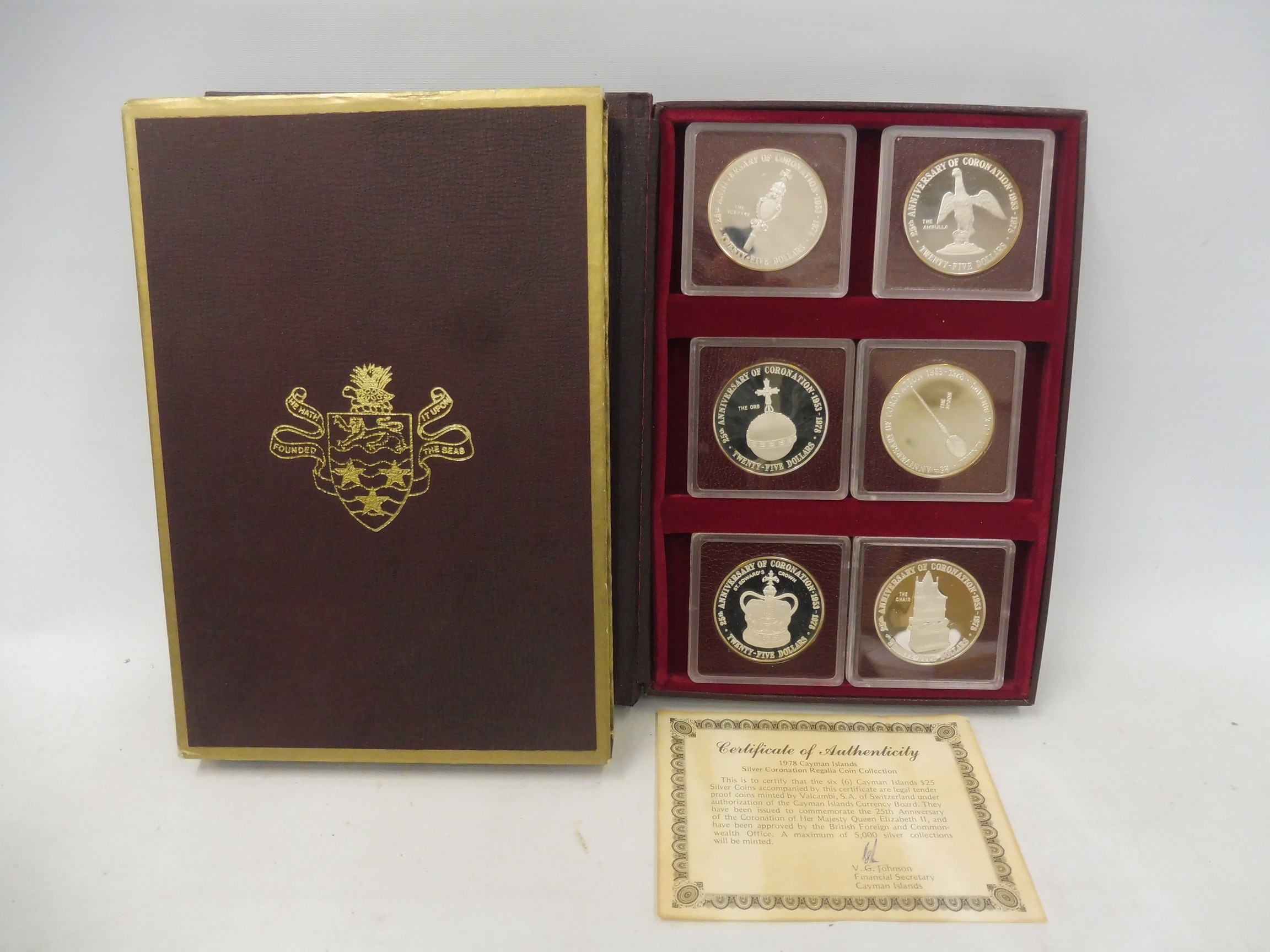 A 1978 Cayman Islands Coronation Regalia Silver Collection, comprising six 25 dollar silver coins,