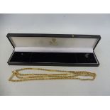 A cased good quality yellow metal necklace, approx 86cm long, approx. 32.3g.