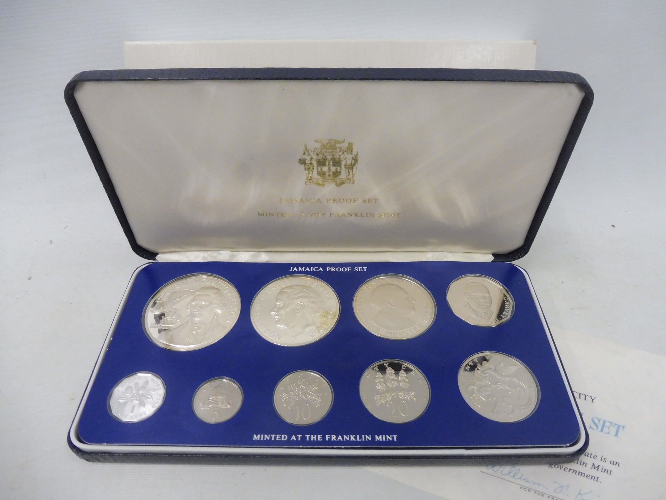 A cased Franklin Mint 1976 Jamaica proof coin set, with certificate, and slip case.