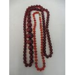 Two necklaces (probably cherry amber) - approx 78cm and approx 38cm.