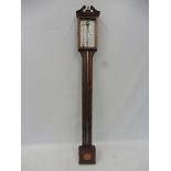 A reproduction mahogany stick barometer by Rapport of London.