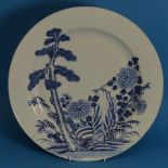 An antique Oriental blue and white porcelain Plate, depicting an exotic landscape, damaged and