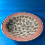 A large studio pottery Bowl, decorated artistically in pinks and blues, with impressed marks to base