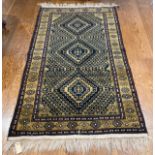 Tribal Rugs; a Turkish hand-knotted rug, the dark gold ground with bold geometric designs in