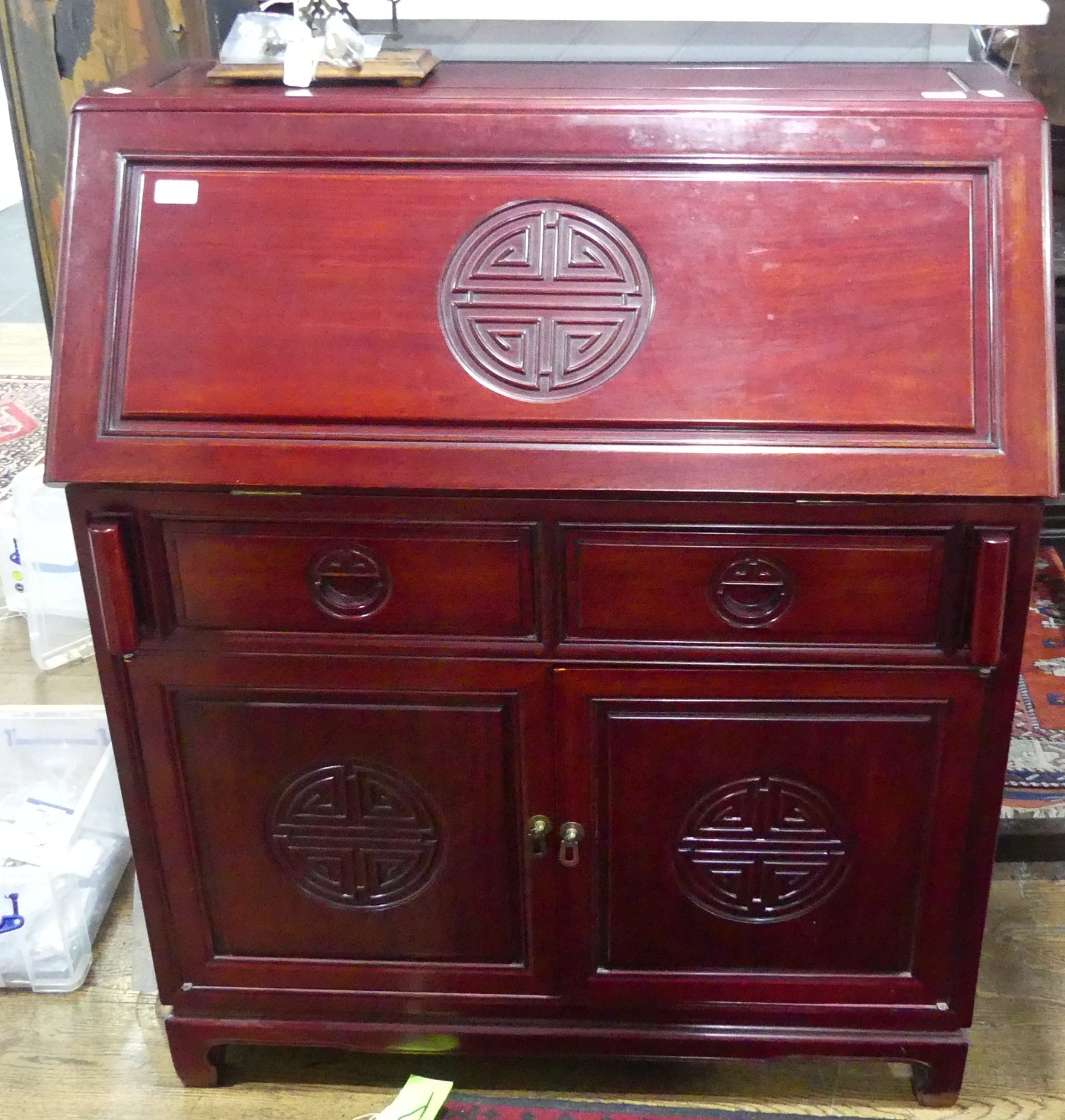 A late 20thC Oriental hardwood Bureau, the fall front with fitted interior, above two short