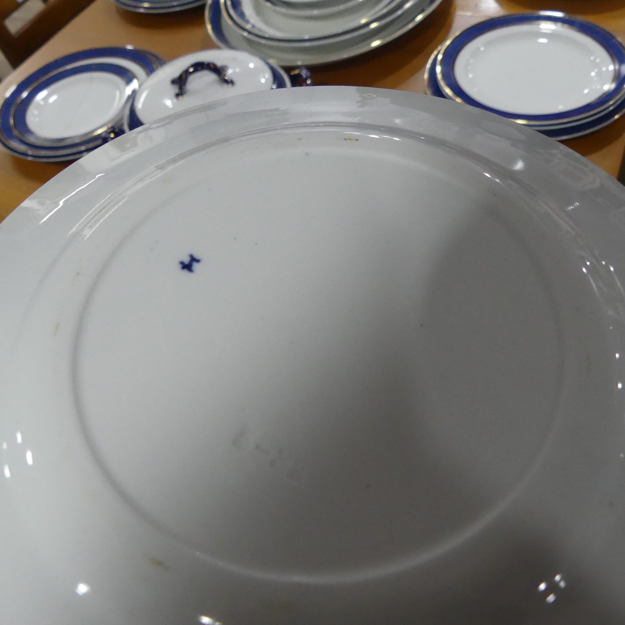 An early 20thC Staffordshire Dinner Service, decorated in blue banding with gilding, comprising five - Image 4 of 8