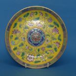 A Chinese Famille Jaune Footed Bowl, the yellow ground decorated with enamels of flora, the