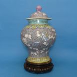 A Chinese Republican period porcelain Temple Jar and Cover, decorated in enamels of purple, blues