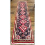 Tribal Rugs: a Persian Senneh hand knotted narrow wool runner, blue ground with dark pink borders,