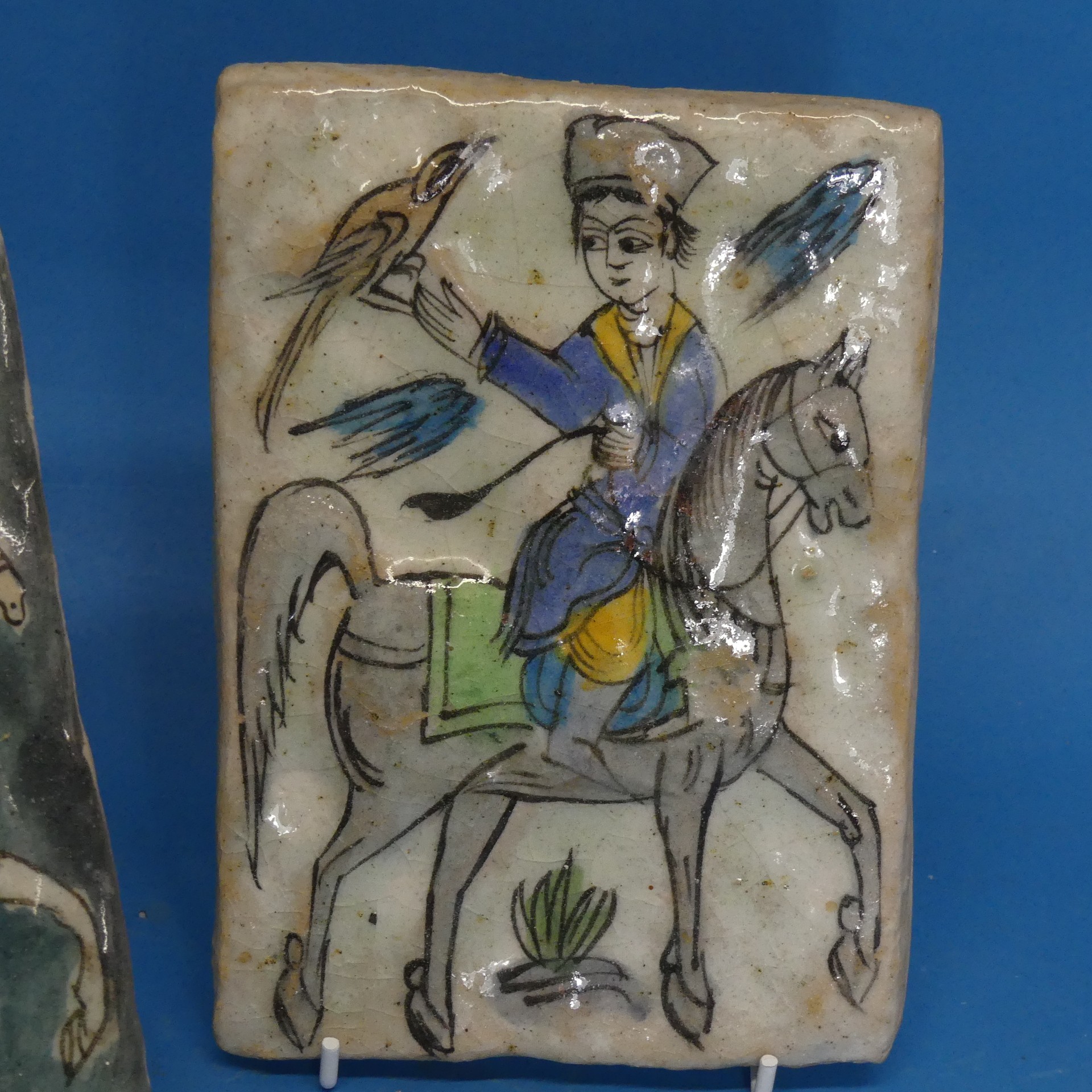 A pair of 19thC Persian Tiles, depicting a horse rider catching birds, somewhat in relief, 13cm x - Image 2 of 4