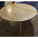A vintage Ercol circular Table, raised on four circular legs with sticker, 44in (112cm) diameterx28n