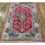 Tribal Rugs; an old hand-knotted wool Persian carpet, red ground with blue border and central