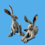 A couple of contemporary raku pottery Hares, one modelled upright and the other recumbant, both with