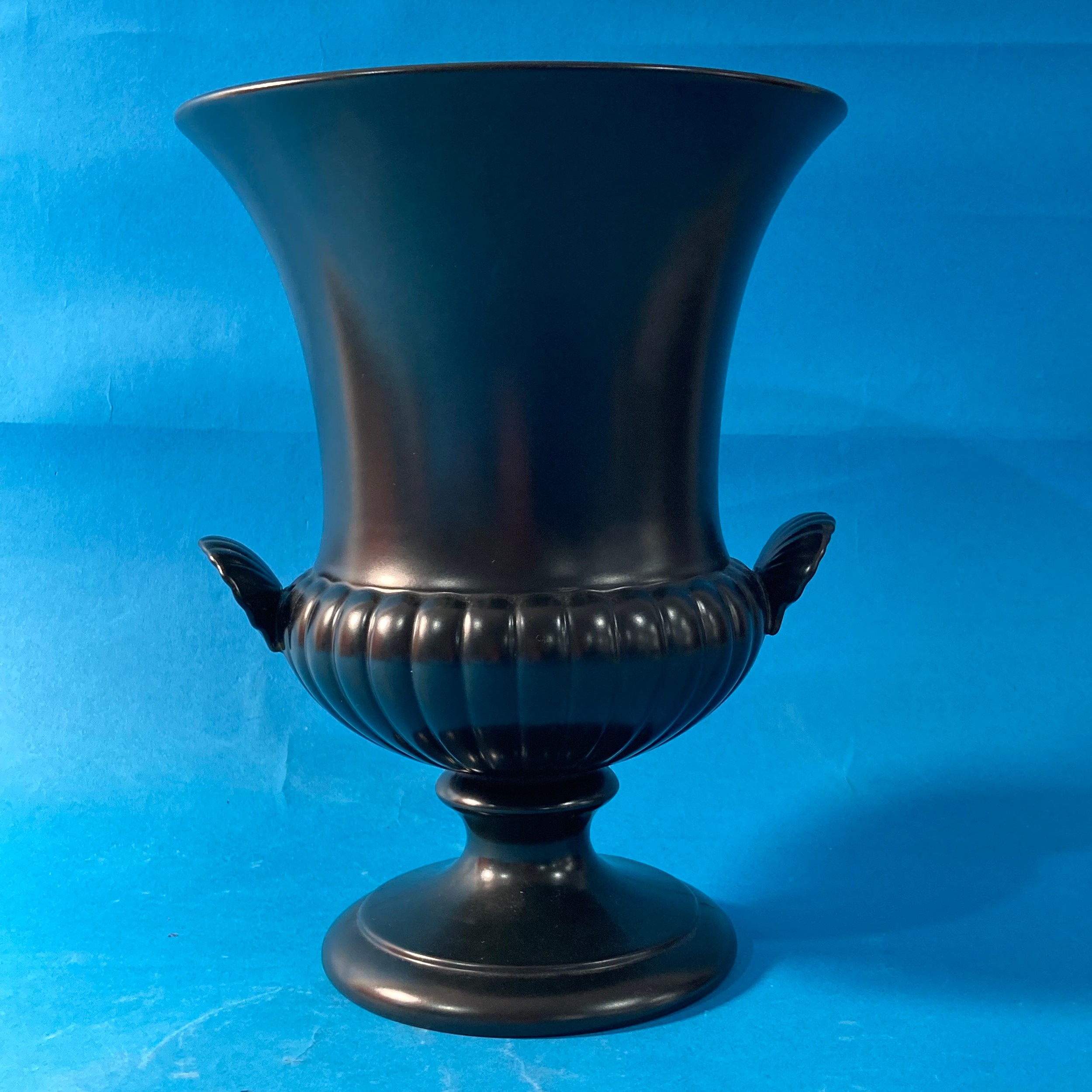 A Wedgwood black porcelain Urn, the twin handled body with impressed marks to base, together with