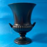 A Wedgwood black porcelain Urn, the twin handled body with impressed marks to base, together with