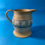 A large antique Mochaware Jug, decorated with banding a large band of foliate decoration, 20cm high.