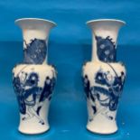A pair of antique Chinese Blue and White Vases, the body decorated with warriors, with a six