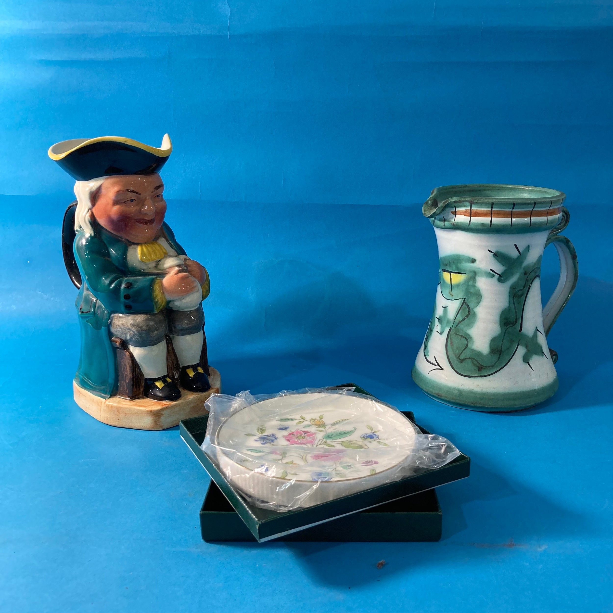 A Tintagel 'Dragon's Eye' pattern pottery Jug, together with a musical Toby Jug and boxed Minton '