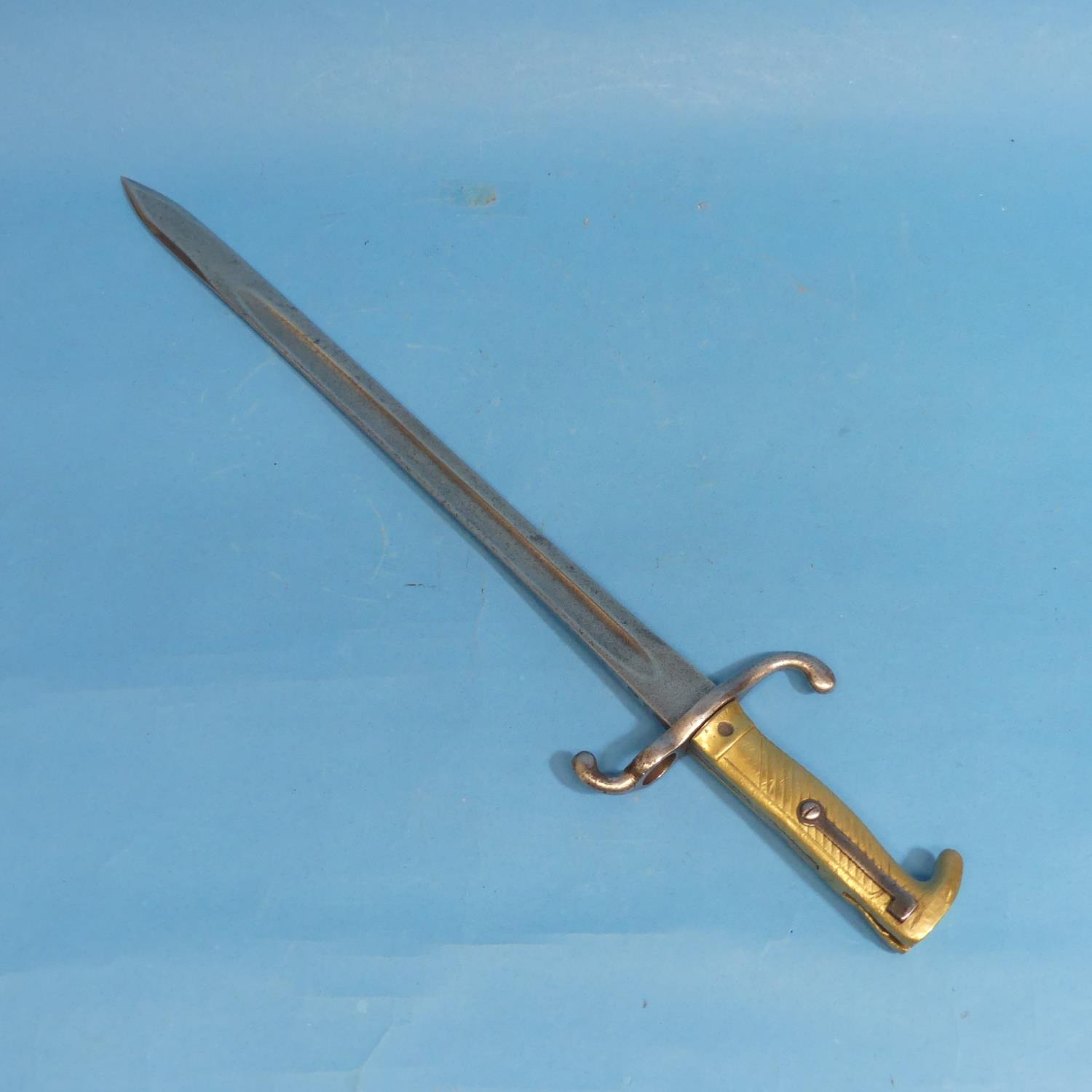 A Mauser Bayonet 1871, the back edge marked 'W75' beneath a crown, with a hooked quillon and a brass