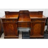 An Edwardian mahogany breakfront Sideboard, with two central drawers flanked by further drawers