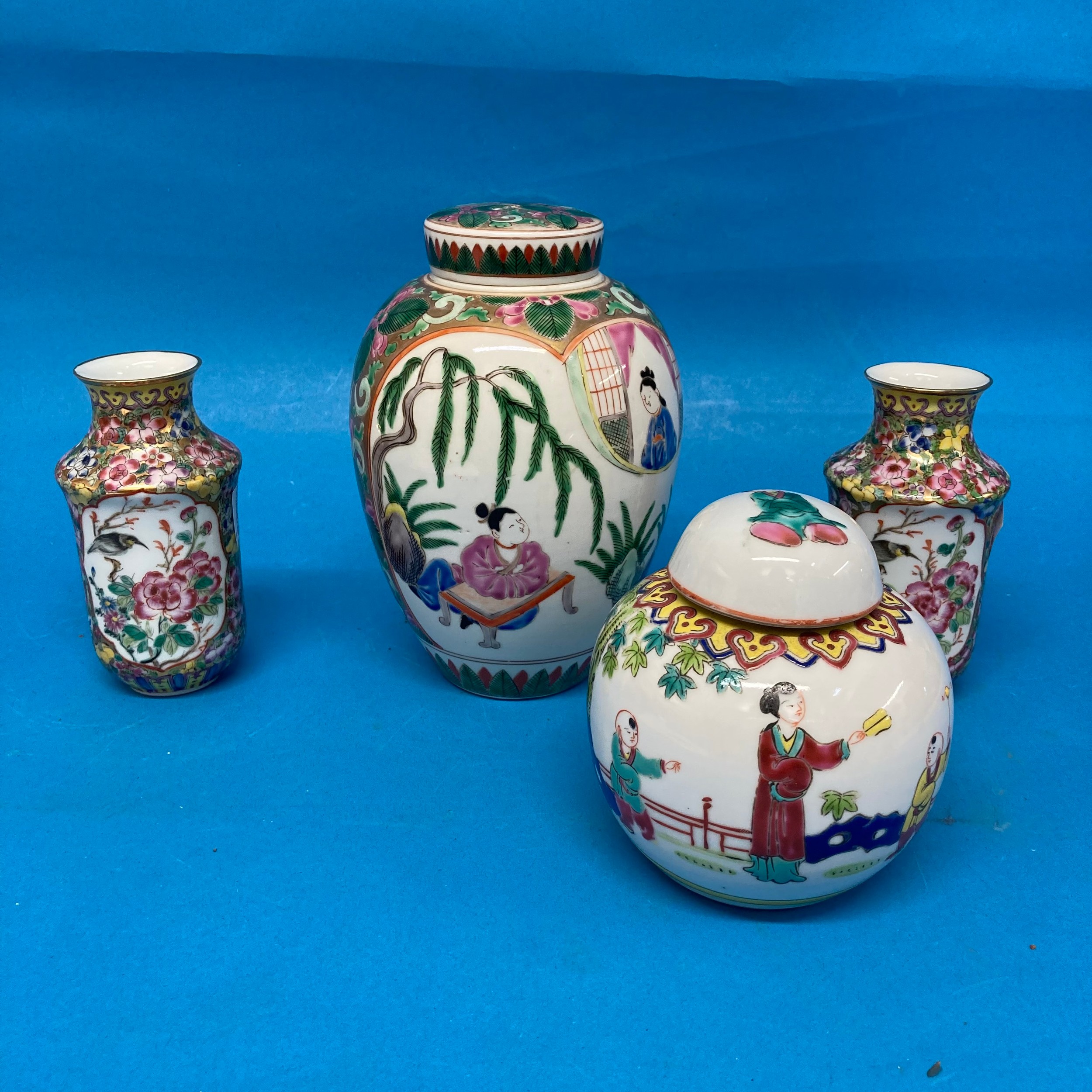 A Chinese famille rose Tobacco Jar, with interior and exterior lids, decorated in typical style with