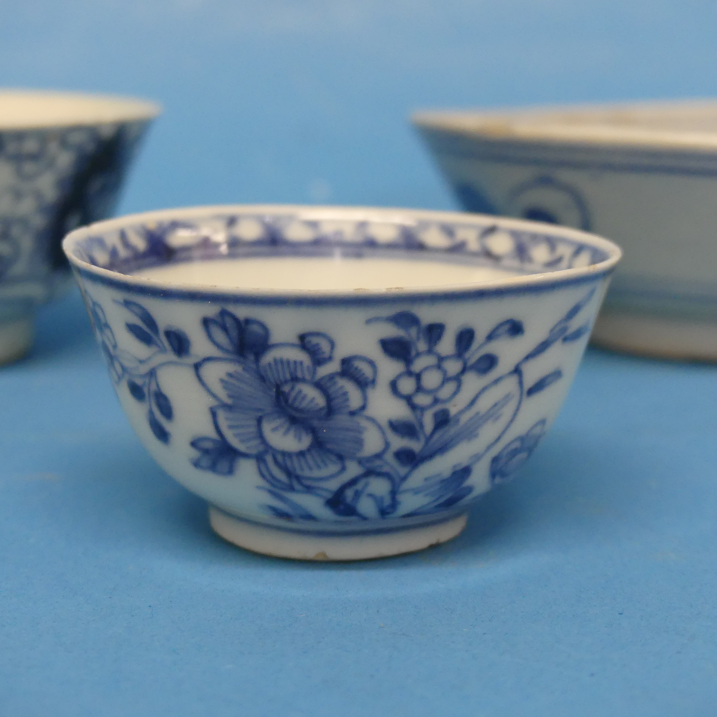 An antique Chinese blue and white Tea Bowl, decorated underglaze with flora, together with two - Image 3 of 6