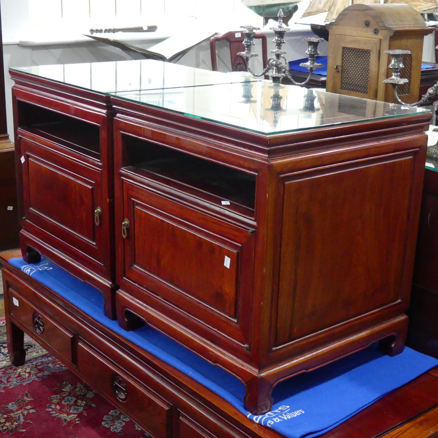 A pair of late 20thC Oriental hardwood Bedside Cabinets, with a single open shelf above a cupboard