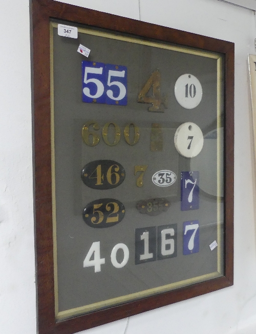 An attractive display of vintage House Numbers, including individual brass numbers, enamel and