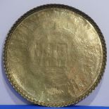 An early 20thC middle-eastern large brass circular Tray/Table Top, embossed with Egyptian deities