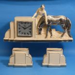 An Art Deco ceramic mantle Clock Garniture, cream ground, depicting a lady and cow, flanked by