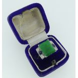 An emerald, sapphire and diamond Ring, the central emerald 12.25mm x 10mm appprox., with two