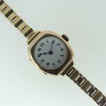 A 9ct gold lady's Wristwatch, with Arabic numerals on white enamel dial, engraved initials and