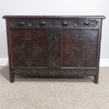 An antique oak Chest, the incised front with hinged lid enclosing vacant interior, raised on stile
