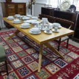 A modern light oak extending Dining Table by Conran, raised on trestle base, with extra leaf,