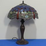 A contemporary Tiffany-style Lamp, the shade of typical style with dragonfly motif, H 56cm.