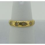 An 18ct yellow gold Band, gypsy set with twelve diamond points, Size N, approx total weight 3.7g.