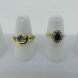 A sapphire and diamond cluster Ring, the central oval sapphire surrounded by small diamond points,