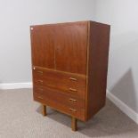 A retro Danish teak Cabinet, the top with cabinet compartment upon four drawers, raised on square