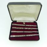 A cased set of four sterling silver 'Bridge' Pencils, the finials enameled in either red or black