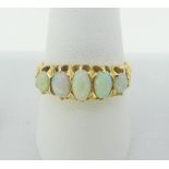 A graduated five stone oval opal Ring, all mounted in 18ct yellow gold, Size N, approx total